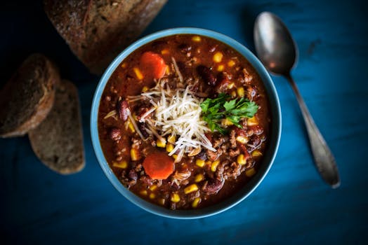 pexels-photo-7111387-7111387 Delicious homemade beef chili served with fresh bread on a rustic table for a cozy meal.
